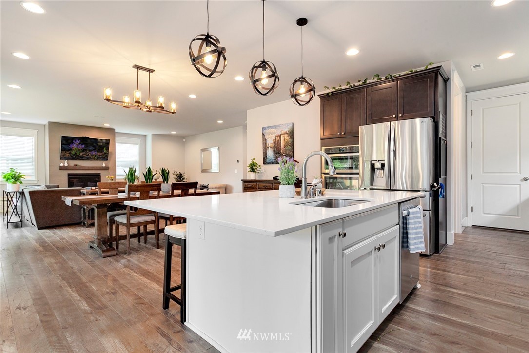 253 Field Place Southeast Renton, WA 98059 - Photo 19 of 40 a kitchen with cabinets a refrigerator and chairs