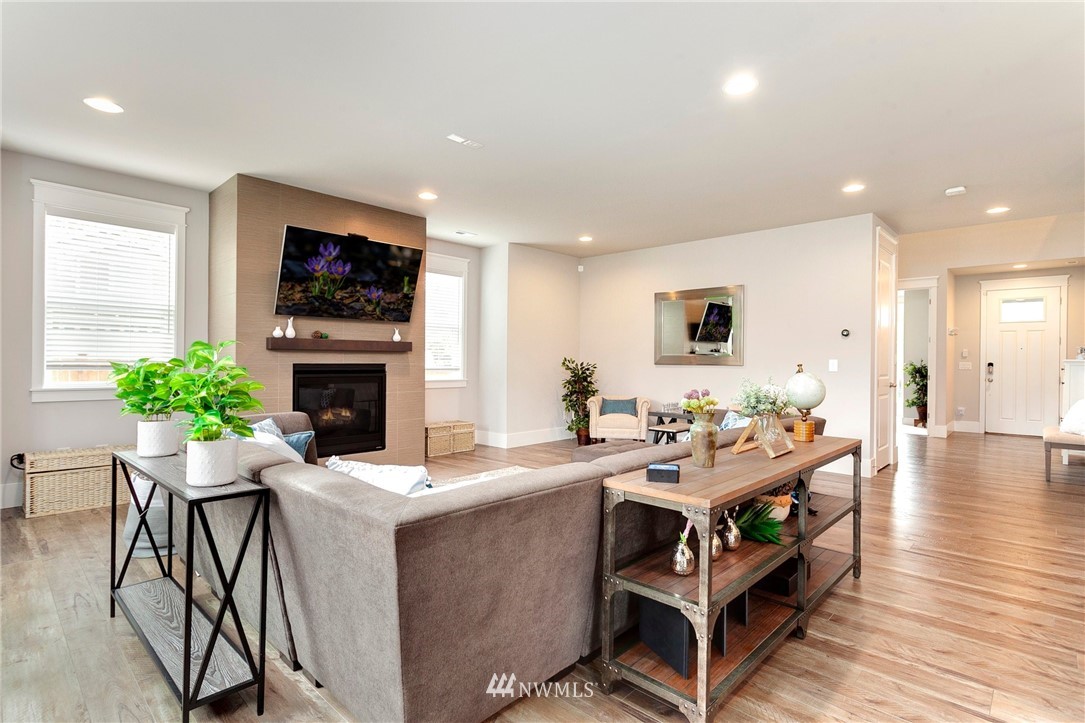 253 Field Place Southeast Renton, WA 98059 - Photo 21 of 40 a living room with furniture a fireplace and a flat screen tv