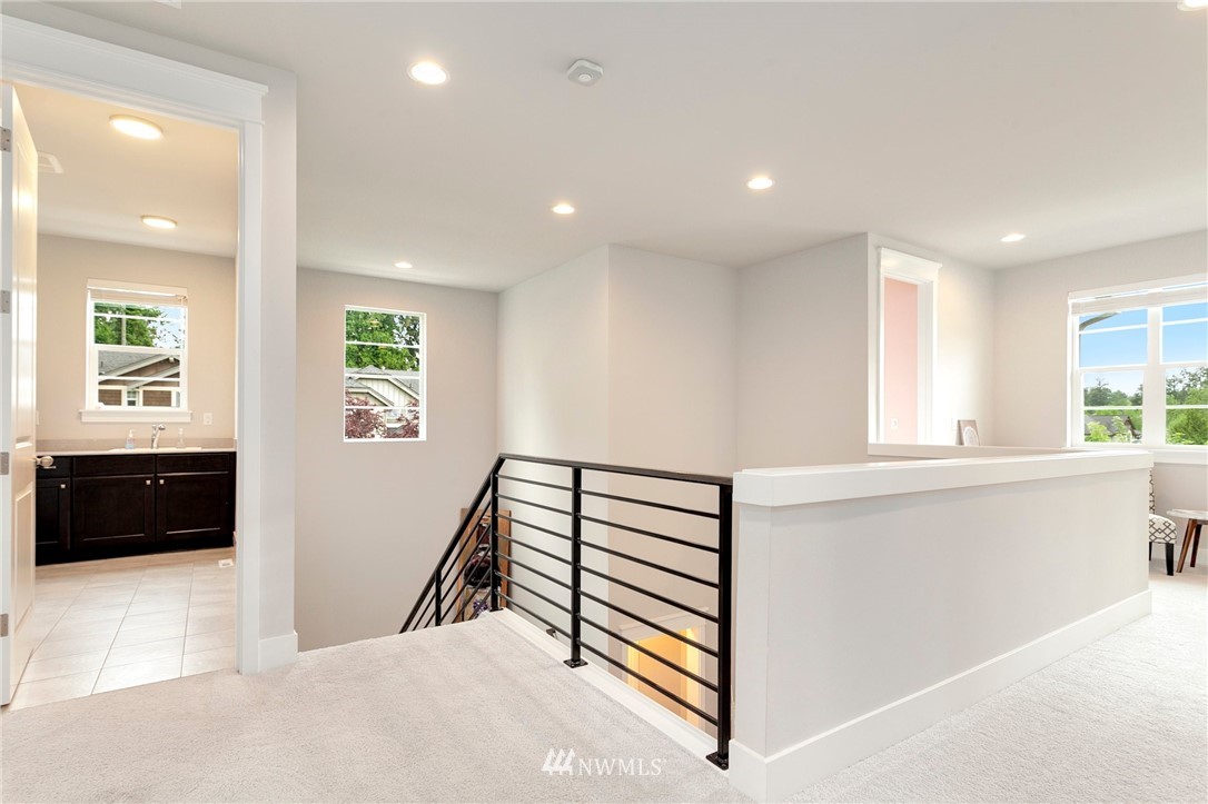 253 Field Place Southeast Renton, WA 98059 - Photo 23 of 40 a view of a hallway with windows and furniture