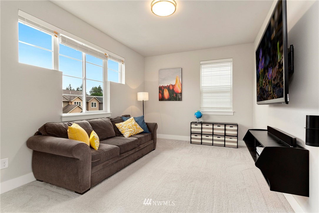 253 Field Place Southeast Renton, WA 98059 - Photo 24 of 40 a living room with furniture and a flat screen tv