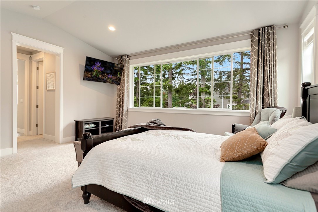 253 Field Place Southeast Renton, WA 98059 - Photo 27 of 40 a bedroom with a bed a window and a flat screen television