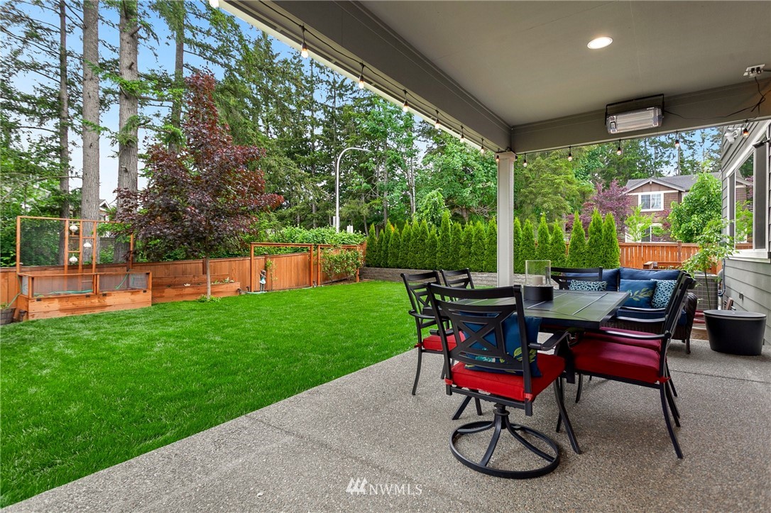 253 Field Place Southeast Renton, WA 98059 - Photo 37 of 40 a view of a chairs and table in patio next to a yard