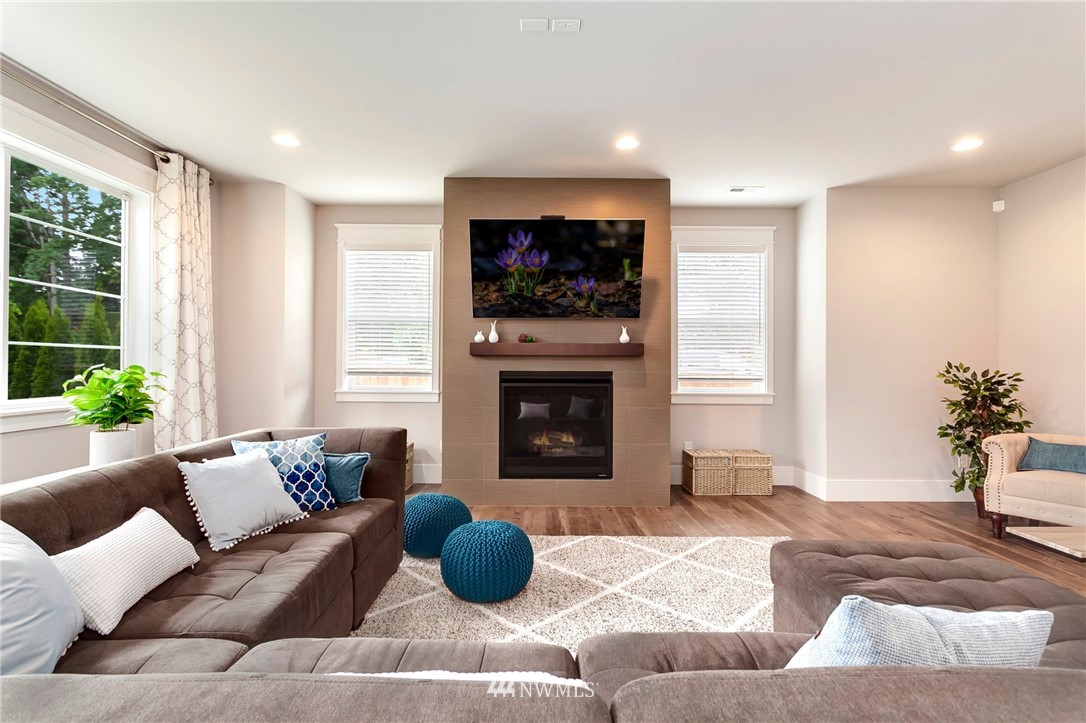 253 Field Place Southeast Renton, WA 98059 - Photo 9 of 40 a living room with furniture and a fireplace