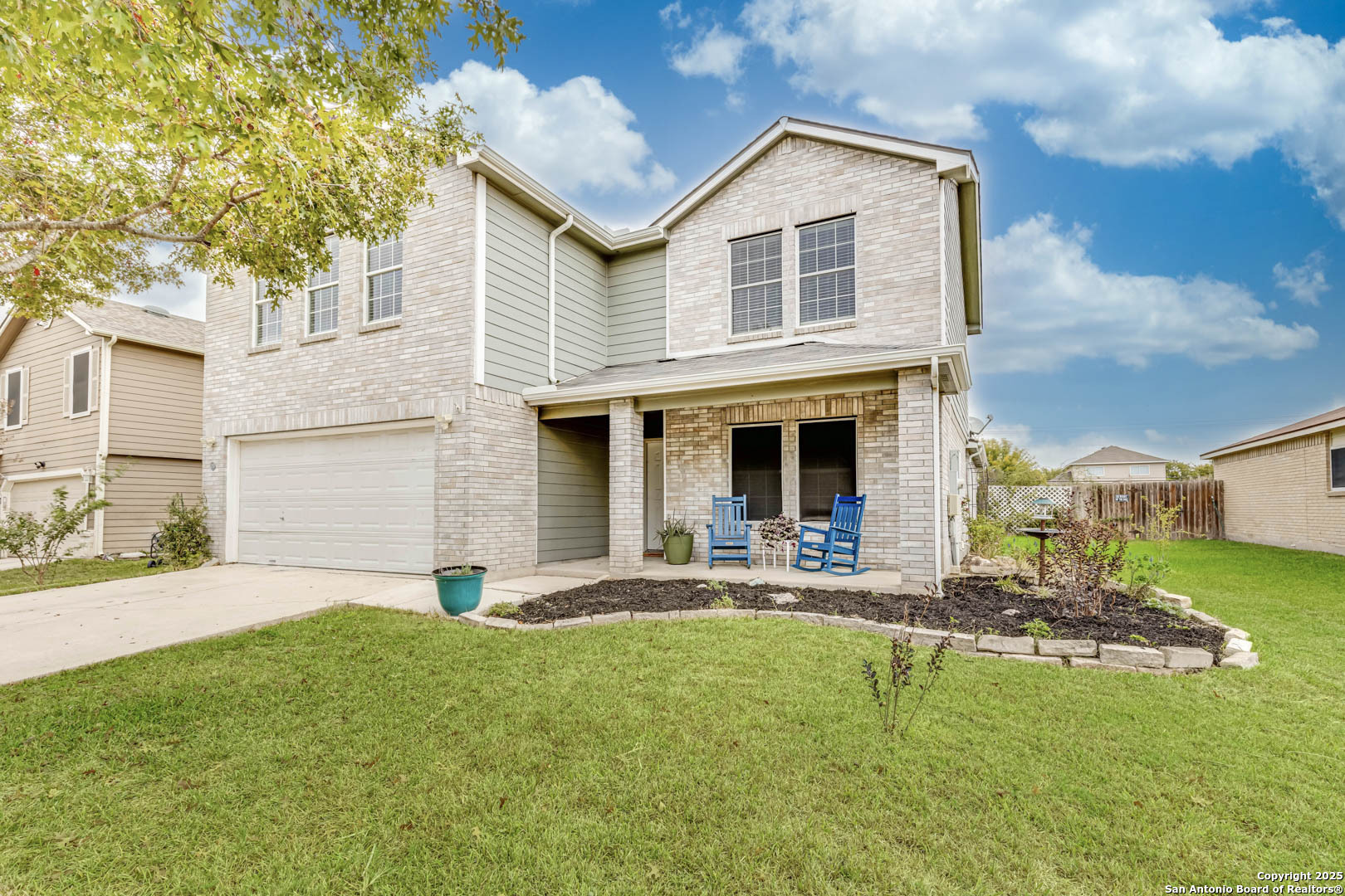 a front view of house with yard and outdoor seating