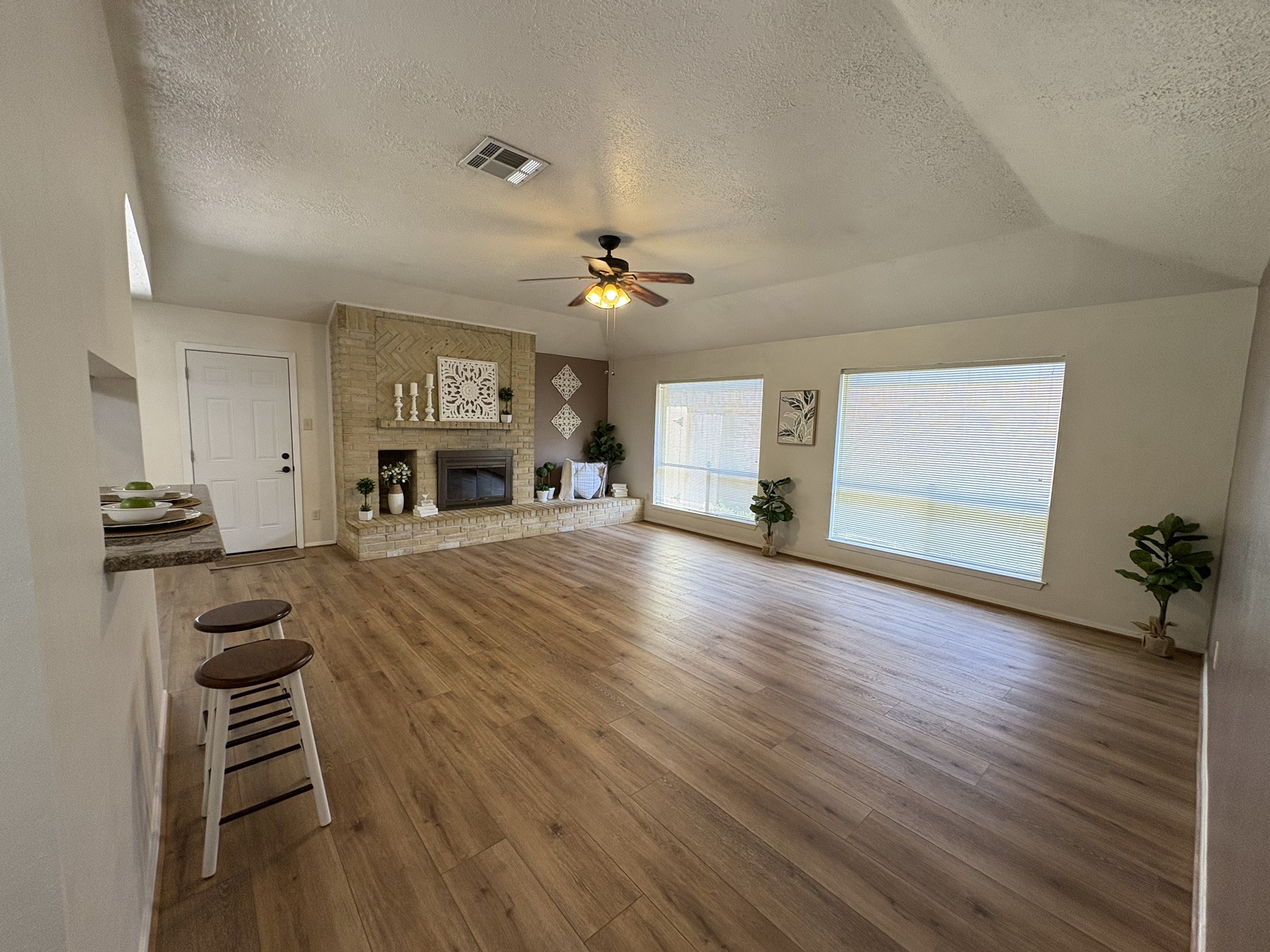 4834 Bridgemont Lane Spring, TX 77388 - Photo 2 of 23 Living Room with Luxury Vinyl Flooring, Vaulted Ceiling and Natural Light