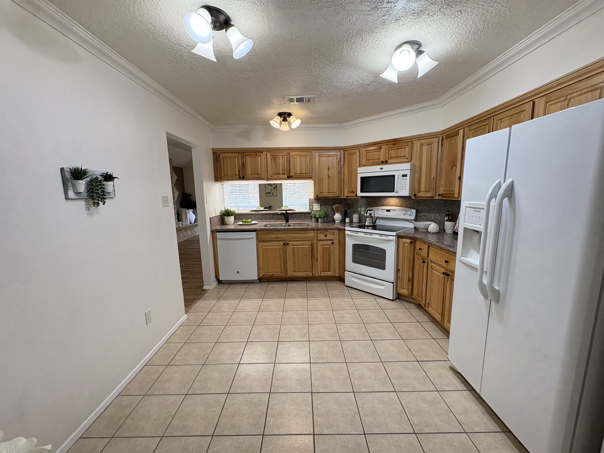 4834 Bridgemont Lane Spring, TX 77388 - Photo 10 of 23 Newer Appliances include Dishwasher, Range and Microwave as well as Side by Side Refrigerator