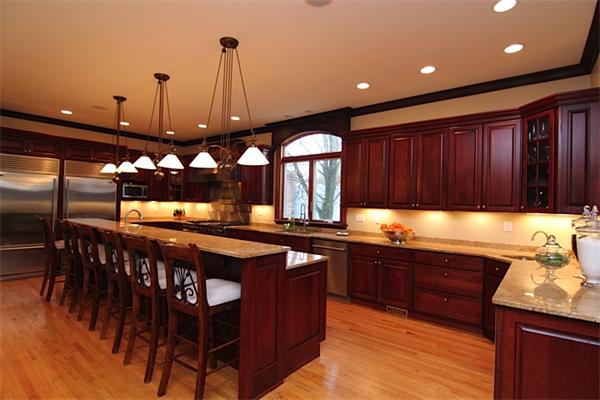 a kitchen with stainless steel appliances granite countertop wooden cabinets a sink and a stove