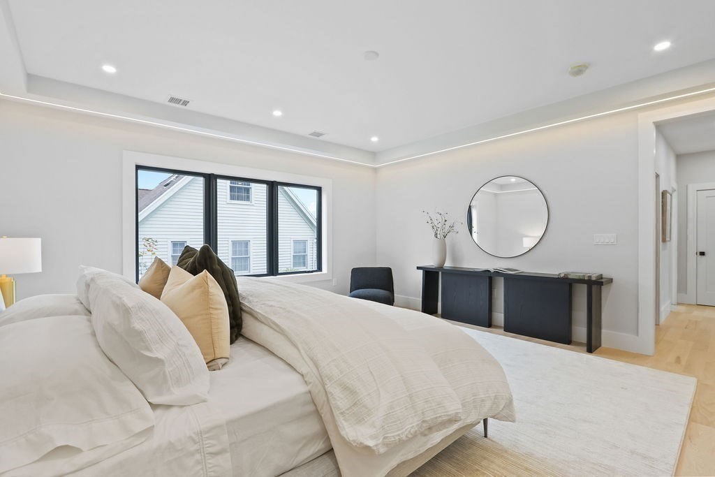 7 Hay Road Newton, MA 02459 - Photo 12 of 20 a bedroom with a large bed and a large mirror