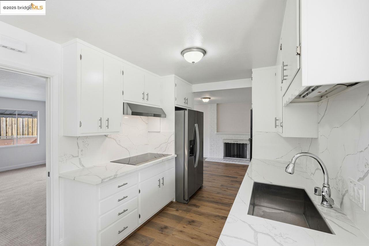 620 Chevy Chase Way Hayward, CA 94544 - Photo 12 of 38 a kitchen with stainless steel appliances a refrigerator sink and cabinets