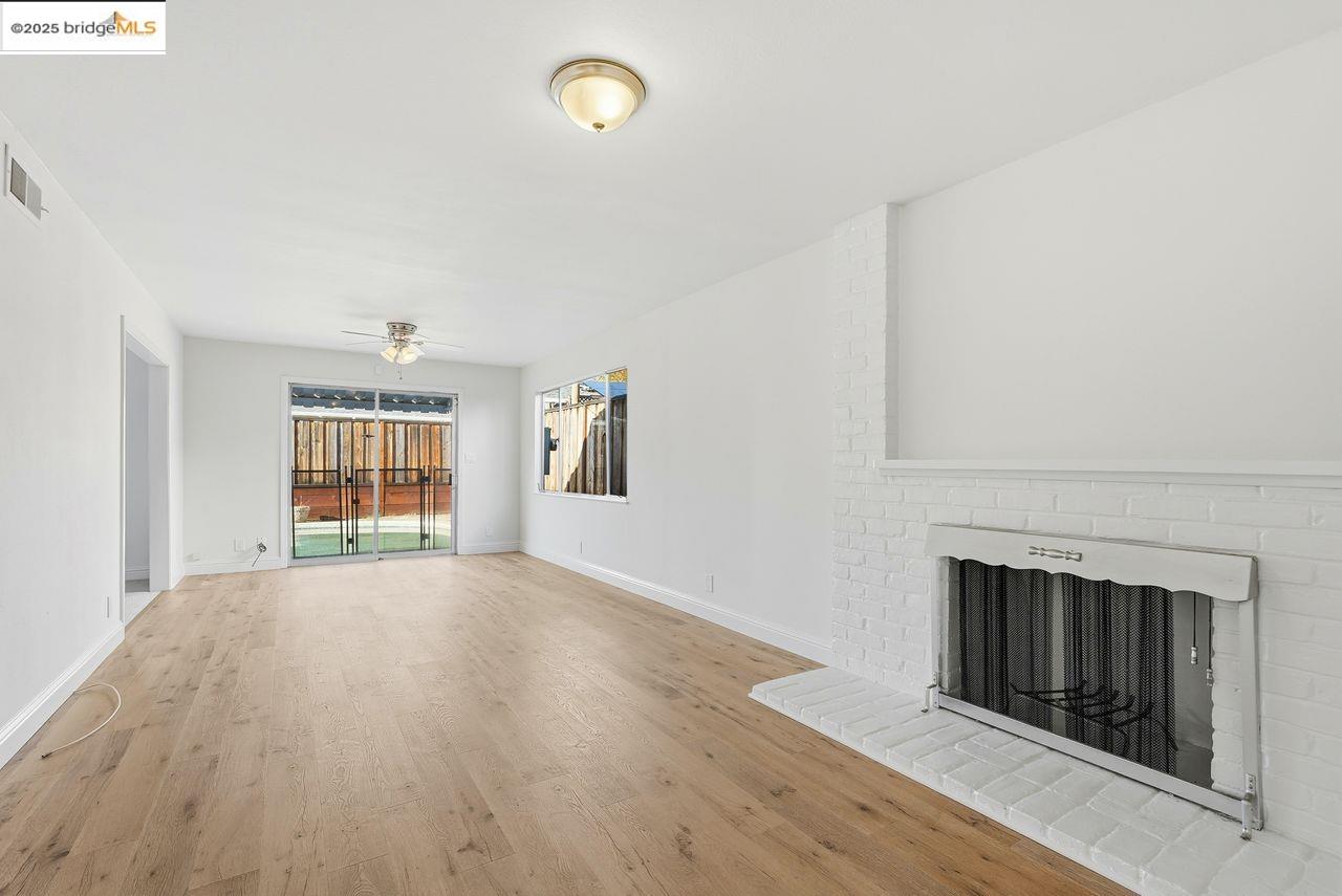 620 Chevy Chase Way Hayward, CA 94544 - Photo 15 of 38 an empty room with windows and fireplace