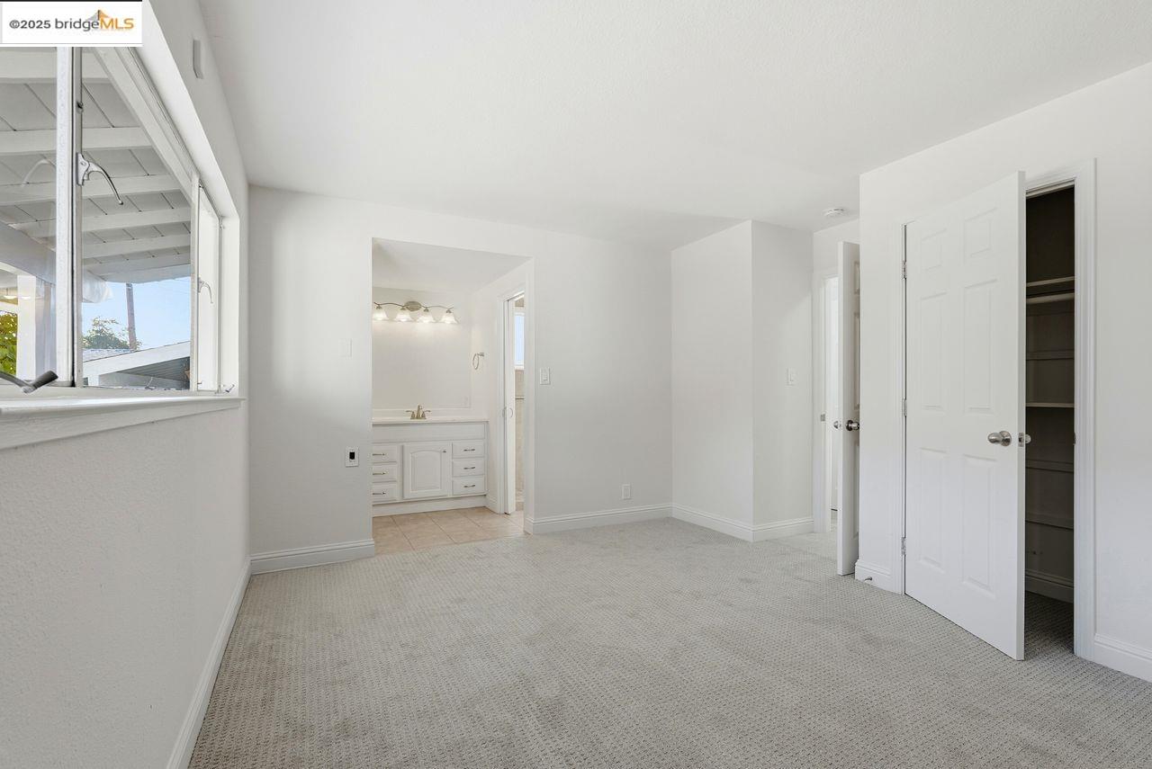 620 Chevy Chase Way Hayward, CA 94544 - Photo 23 of 38 an empty room with a window and a kitchen