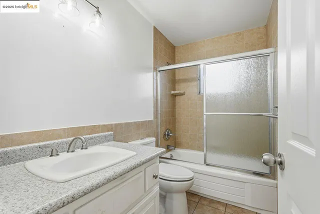 a bathroom with a shower sink and mirror
