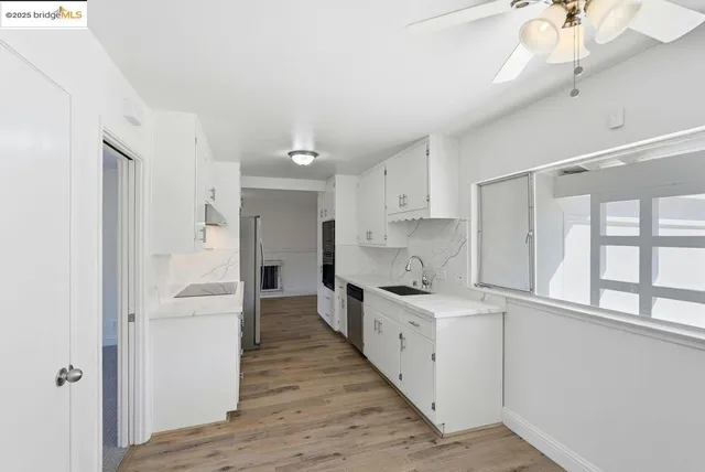 a large kitchen with a stove and a refrigerator