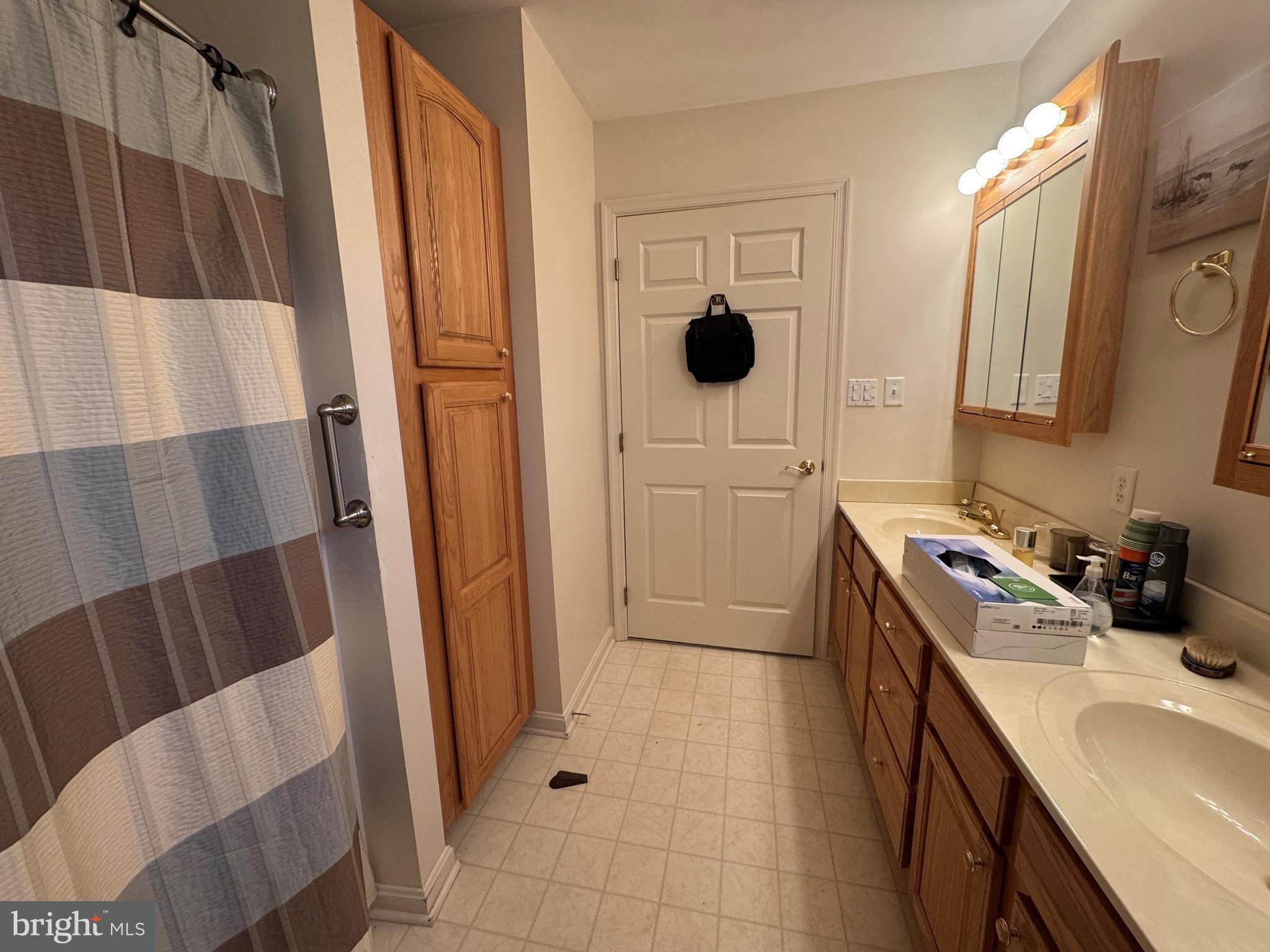 720 Naples Drive Hagerstown, MD 21740 - Photo 11 of 19 a bathroom with a sink and a mirror