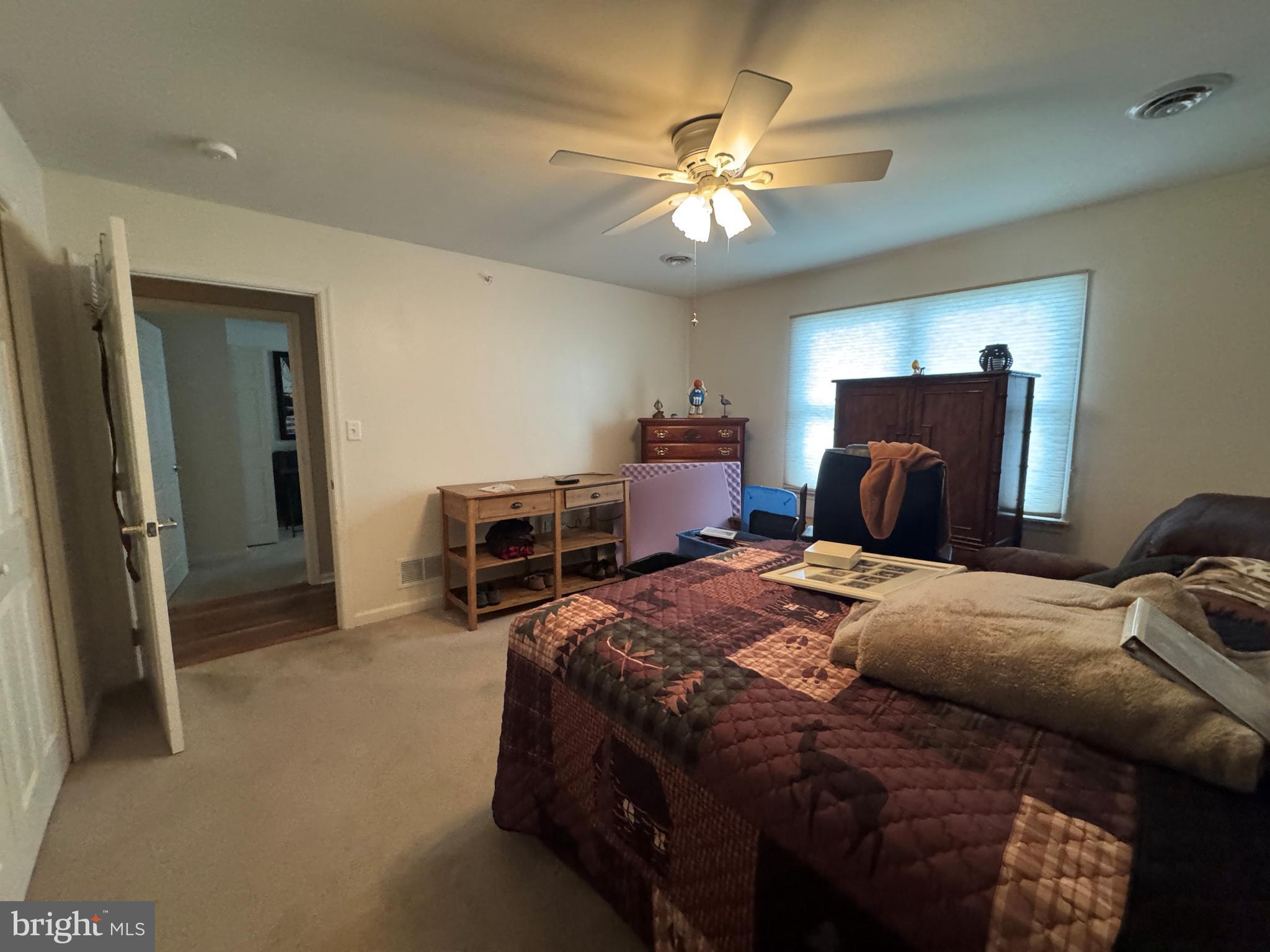 720 Naples Drive Hagerstown, MD 21740 - Photo 8 of 19 a bedroom with a bed and a chandelier