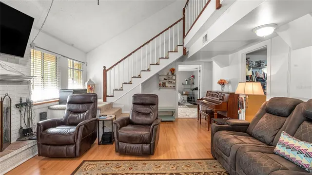 a living room with furniture fireplace and flat screen tv