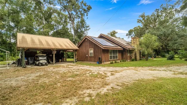 a view of a house with a yard and sitting area