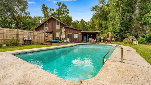 a view of a house with swimming pool and sitting area