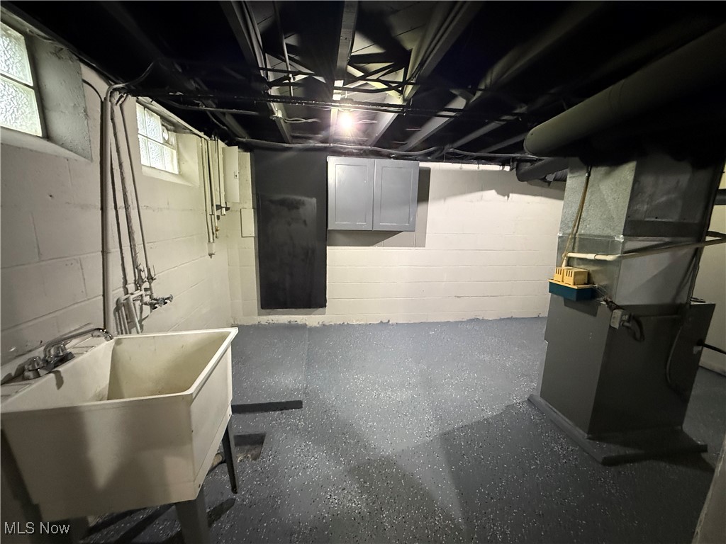 6807 Gerald Avenue Parma, OH 44129 - Photo 23 of 25 Basement with a sink and heating unit