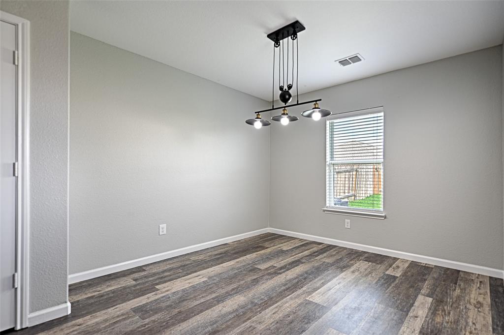 129 Lamont Road Anna, TX 75409 - Photo 16 of 40 a view of empty room with window and wooden floor