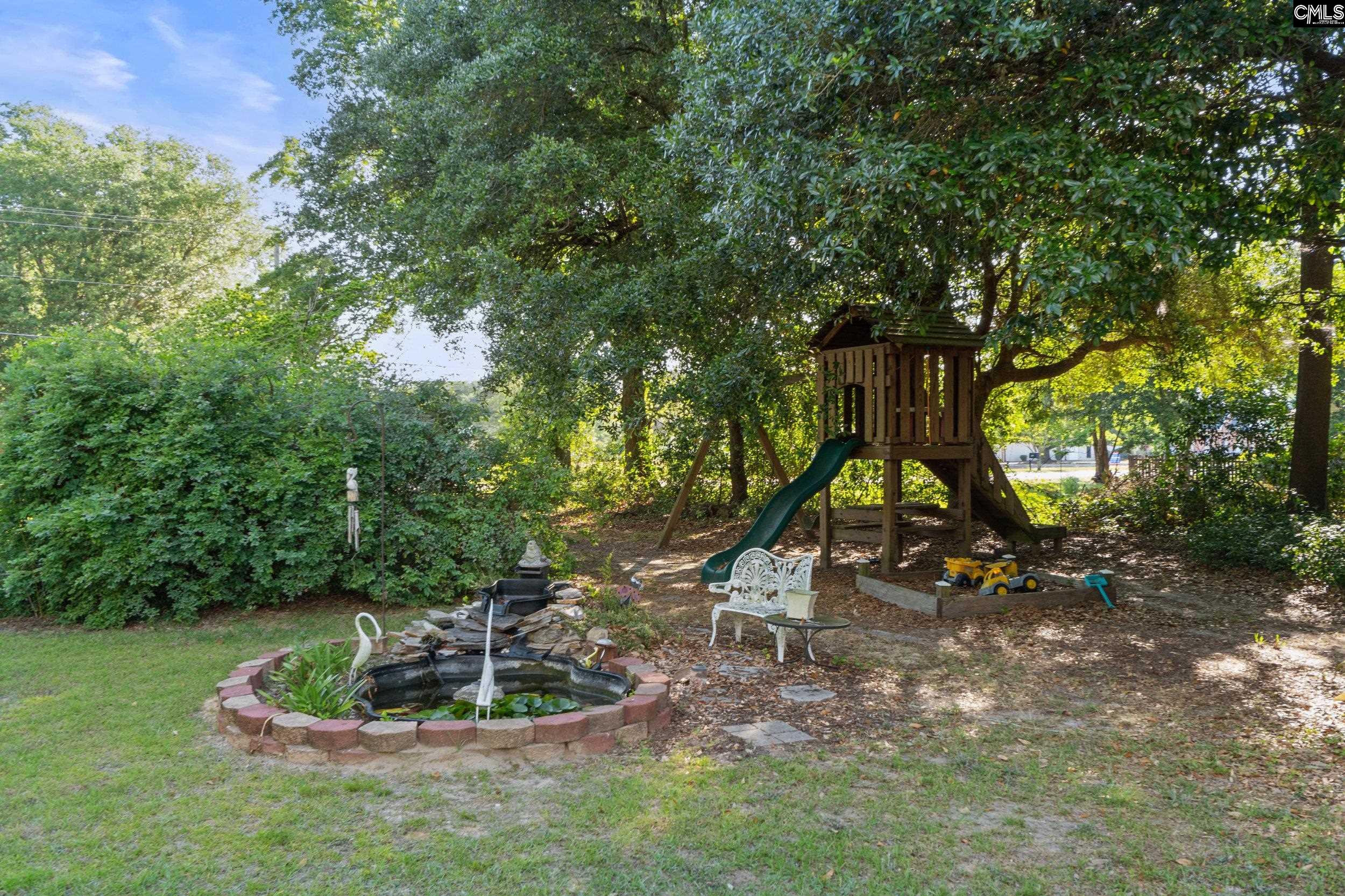 729 Magnolia Street Pelion, SC 29123 - Photo 30 of 32 a park with a bench and trees