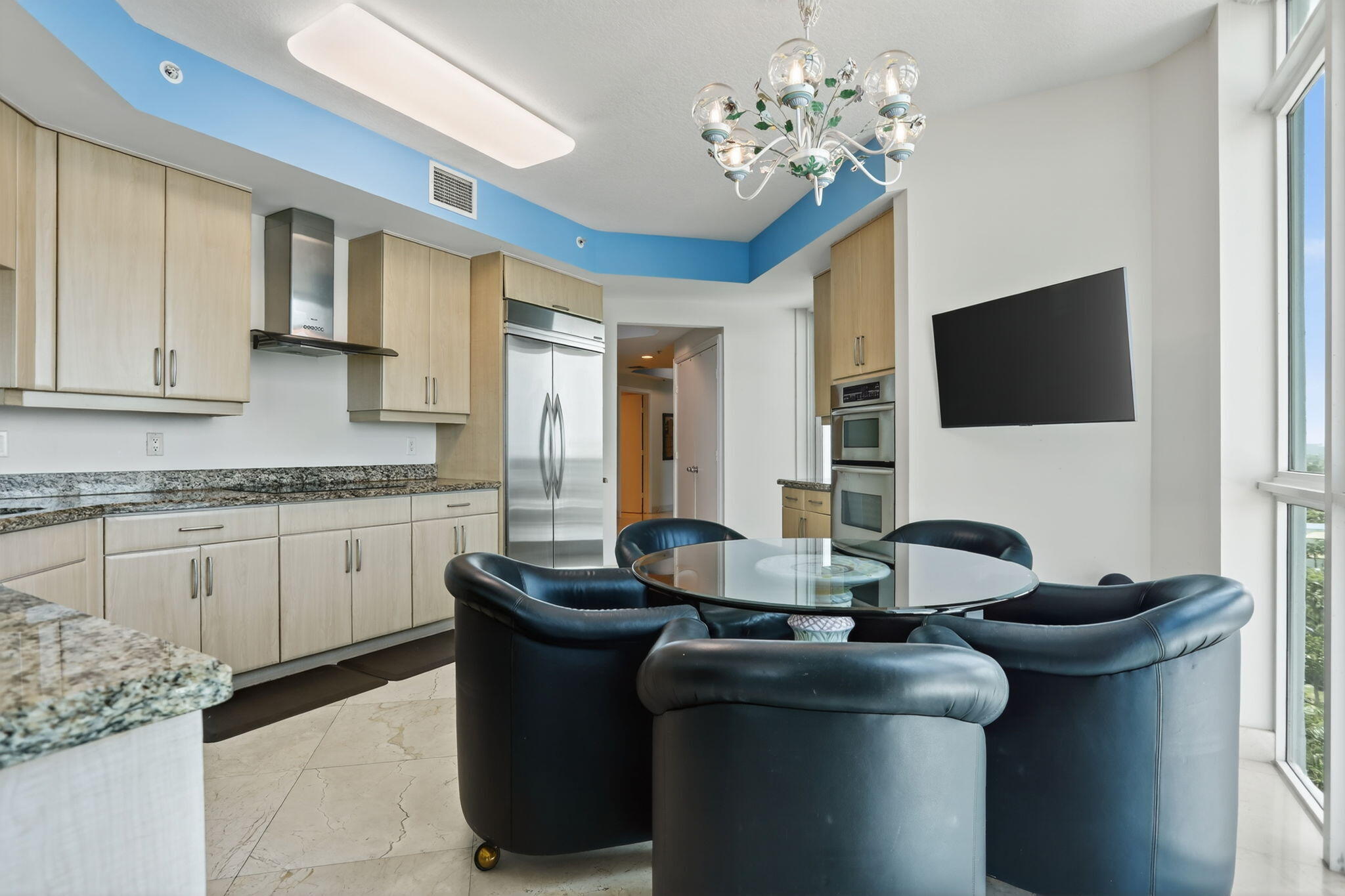 1430 South Ocean Boulevard, Unit 10A Lauderdale-by-the-Sea, FL 33062 - Photo 11 of 97 a living room with furniture a flat screen tv and kitchen view