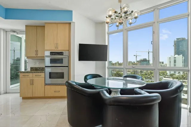 a kitchen with granite countertop white cabinets and a sink
