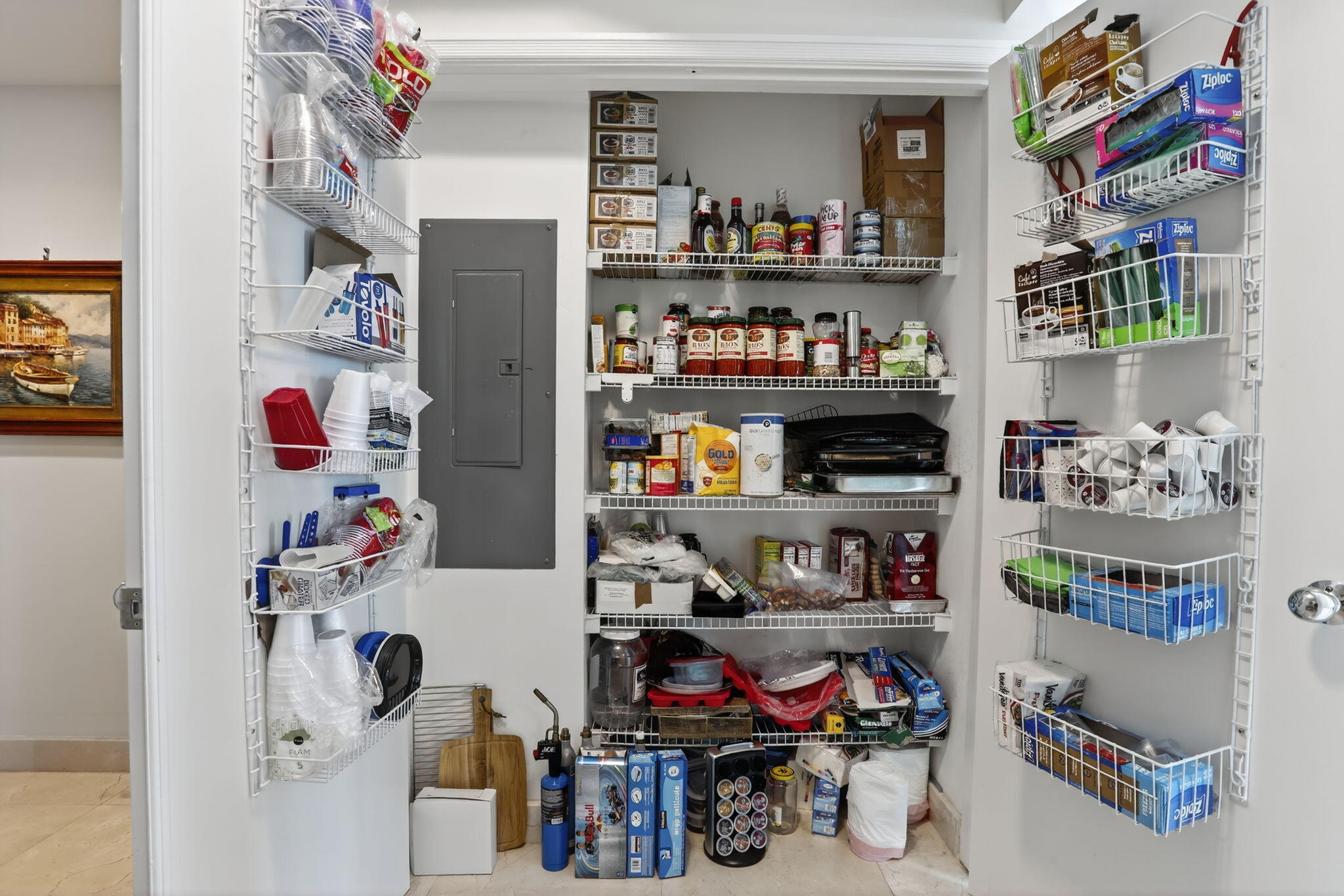 1430 South Ocean Boulevard, Unit 10A Lauderdale-by-the-Sea, FL 33062 - Photo 16 of 97 a room with storage and a shelf with books and knick knacks on it