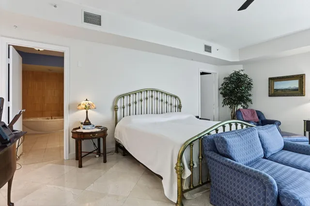 a bedroom with a bed and ceiling fan