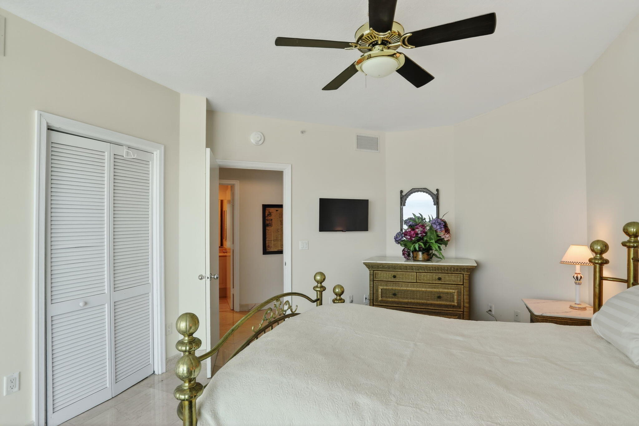 1430 South Ocean Boulevard, Unit 10A Lauderdale-by-the-Sea, FL 33062 - Photo 29 of 97 a bedroom with a bed and ceiling fan