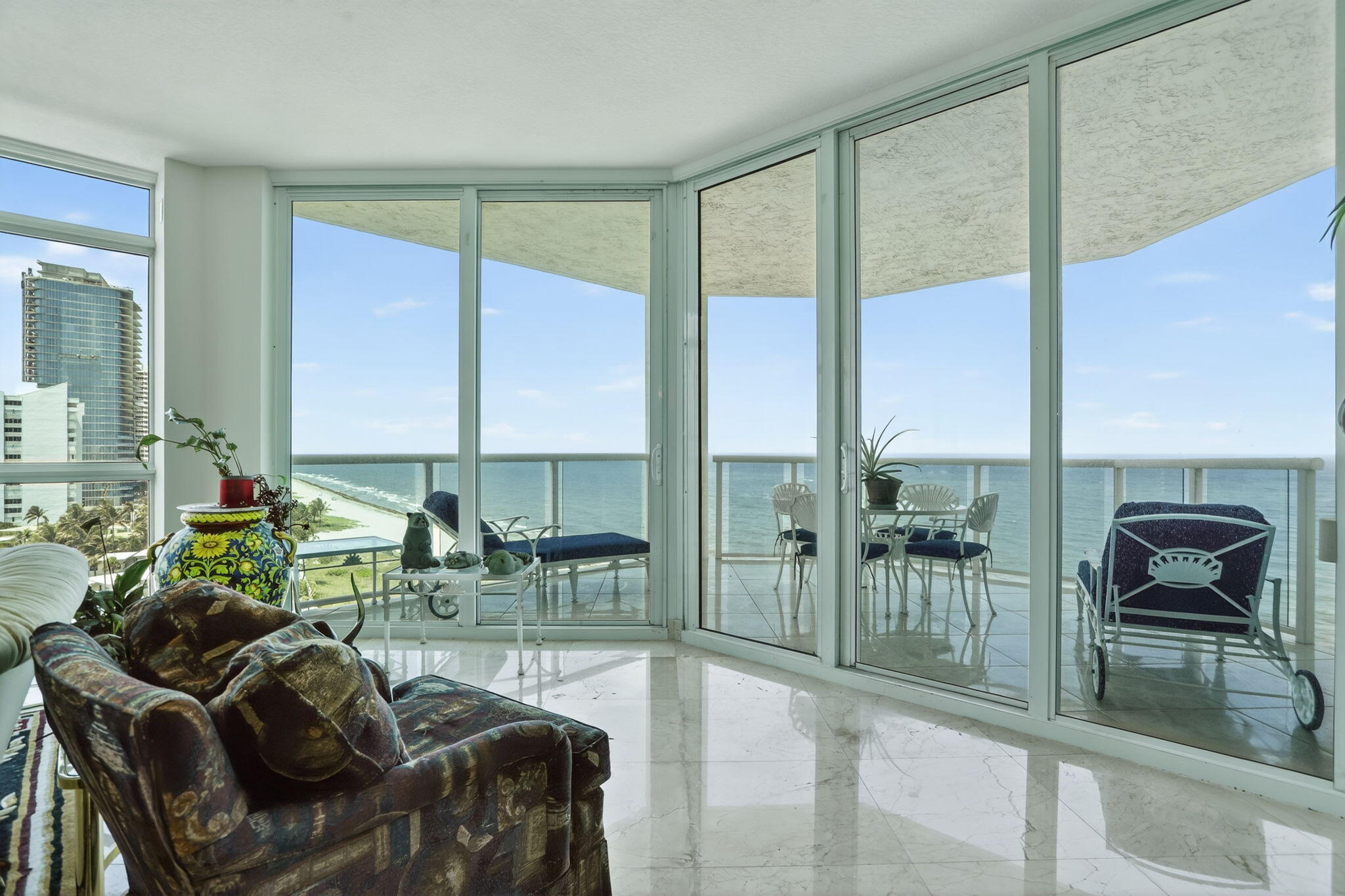 1430 South Ocean Boulevard, Unit 10A Lauderdale-by-the-Sea, FL 33062 - Photo 40 of 97 a living room with furniture and a floor to ceiling window
