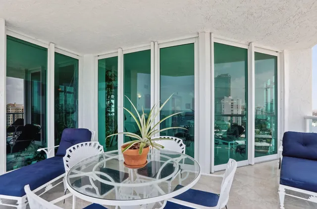 a living room with furniture a large window and a flat screen tv