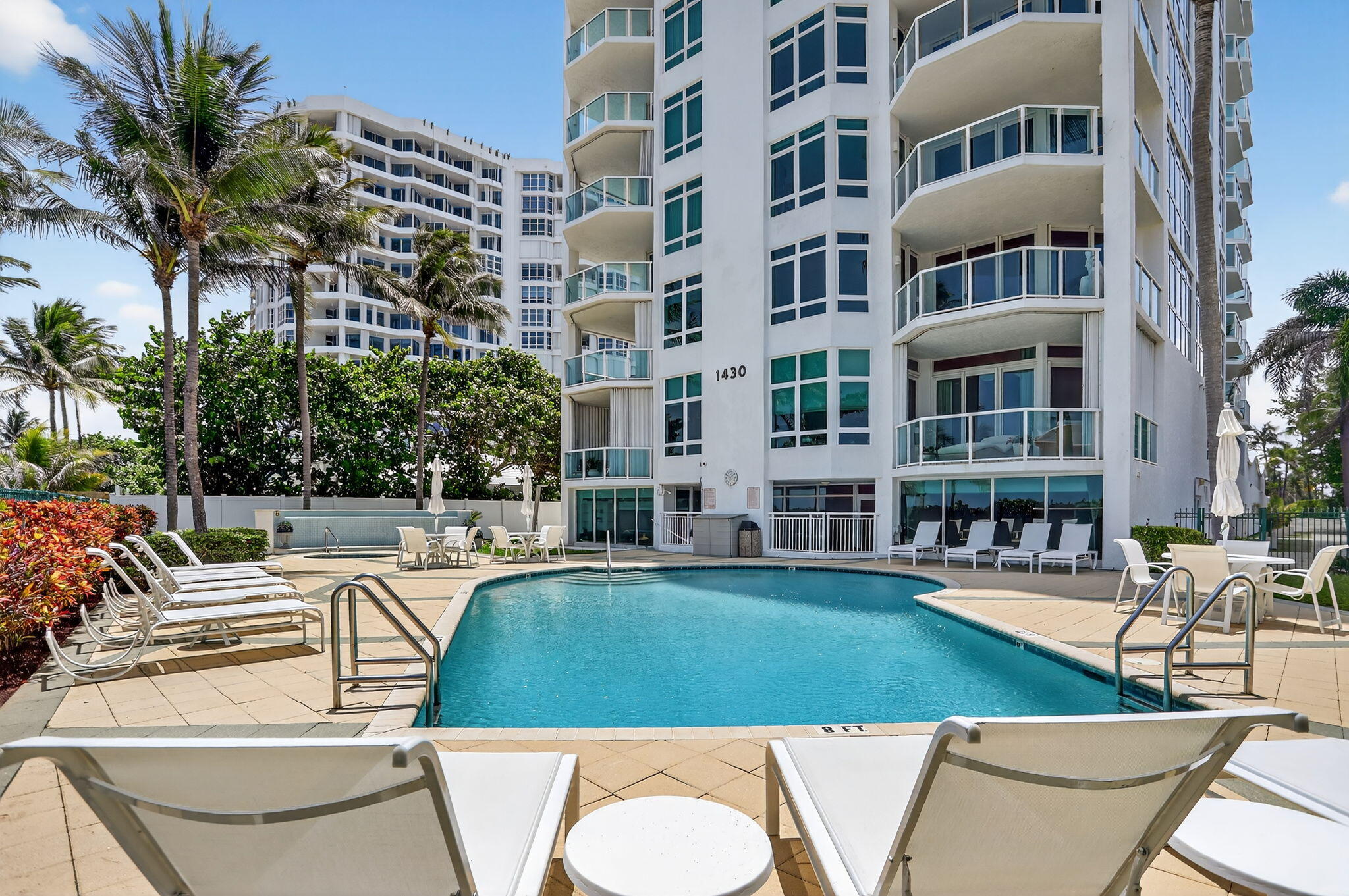 1430 South Ocean Boulevard, Unit 10A Lauderdale-by-the-Sea, FL 33062 - Photo 58 of 97 a view of a swimming pool with outdoor seating and plants