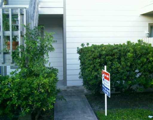 1011 Ennis Joslin Road, Unit 113 Corpus Christi, TX 78412 - Photo 1 of 5 a sign that is on the side of a house