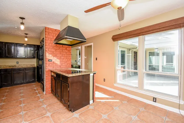 a kitchen with stainless steel appliances granite countertop a stove and a sink