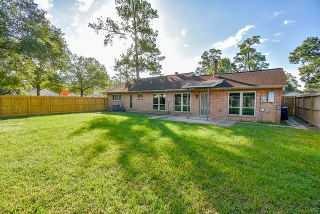 a front view of a house with yard and green space