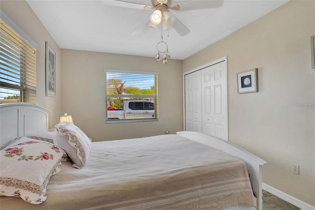 250 Bangsberg Road Southeast Port Charlotte, FL 33952 - Photo 12 of 59 a bedroom with a bed and a window
