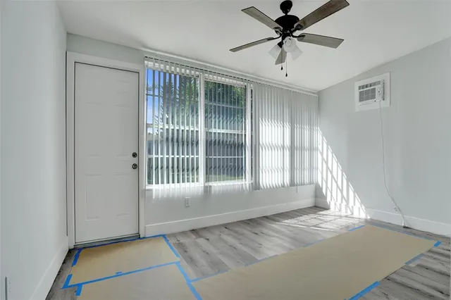 a view of a livingroom with a ceiling fan and window