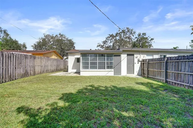 a view of a house with a yard and sitting area