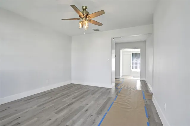 an empty room with wooden floor and door