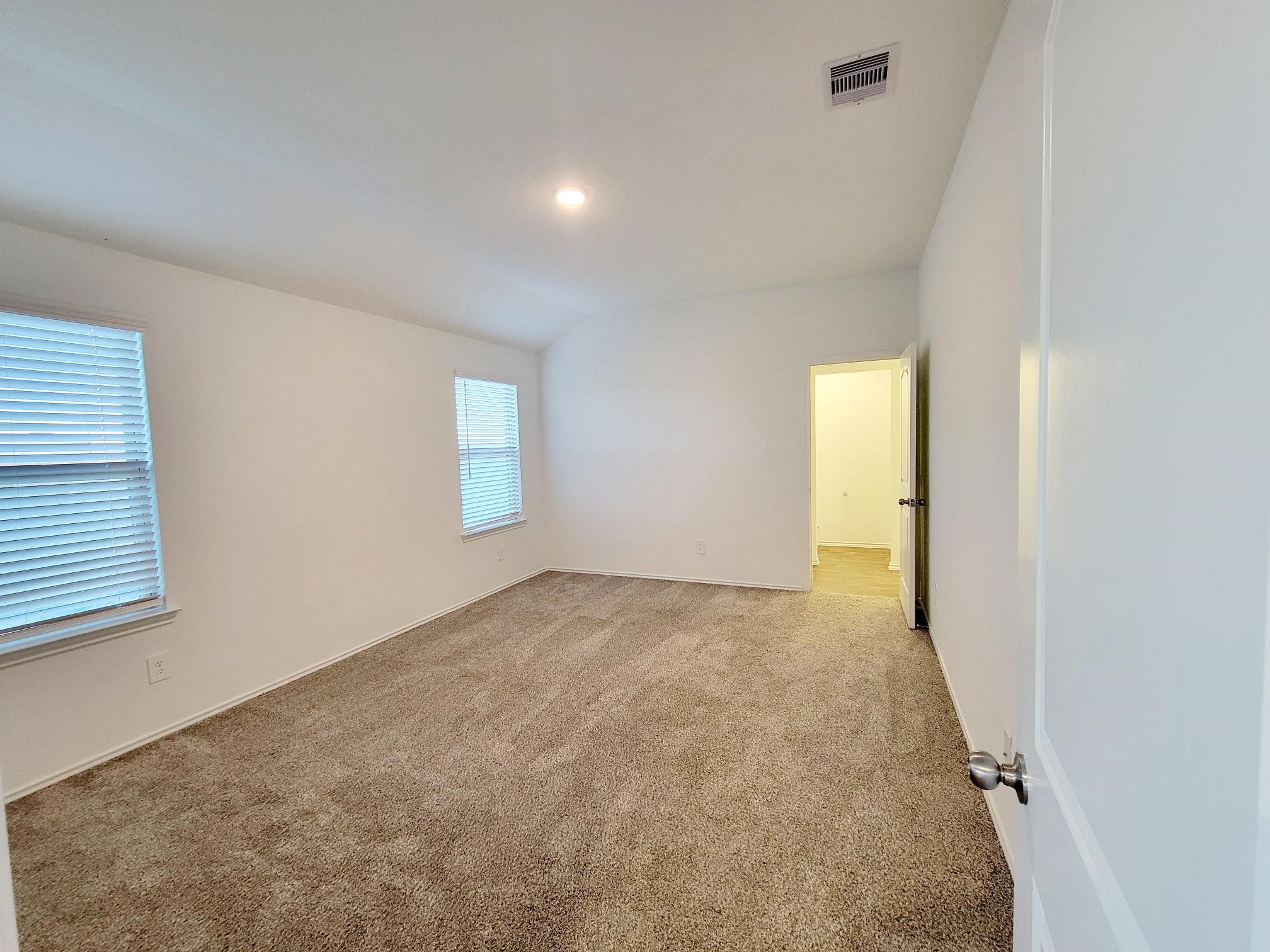 21522 Violet Ridge Road Katy, TX 77449 - Photo 12 of 40 an empty room with windows