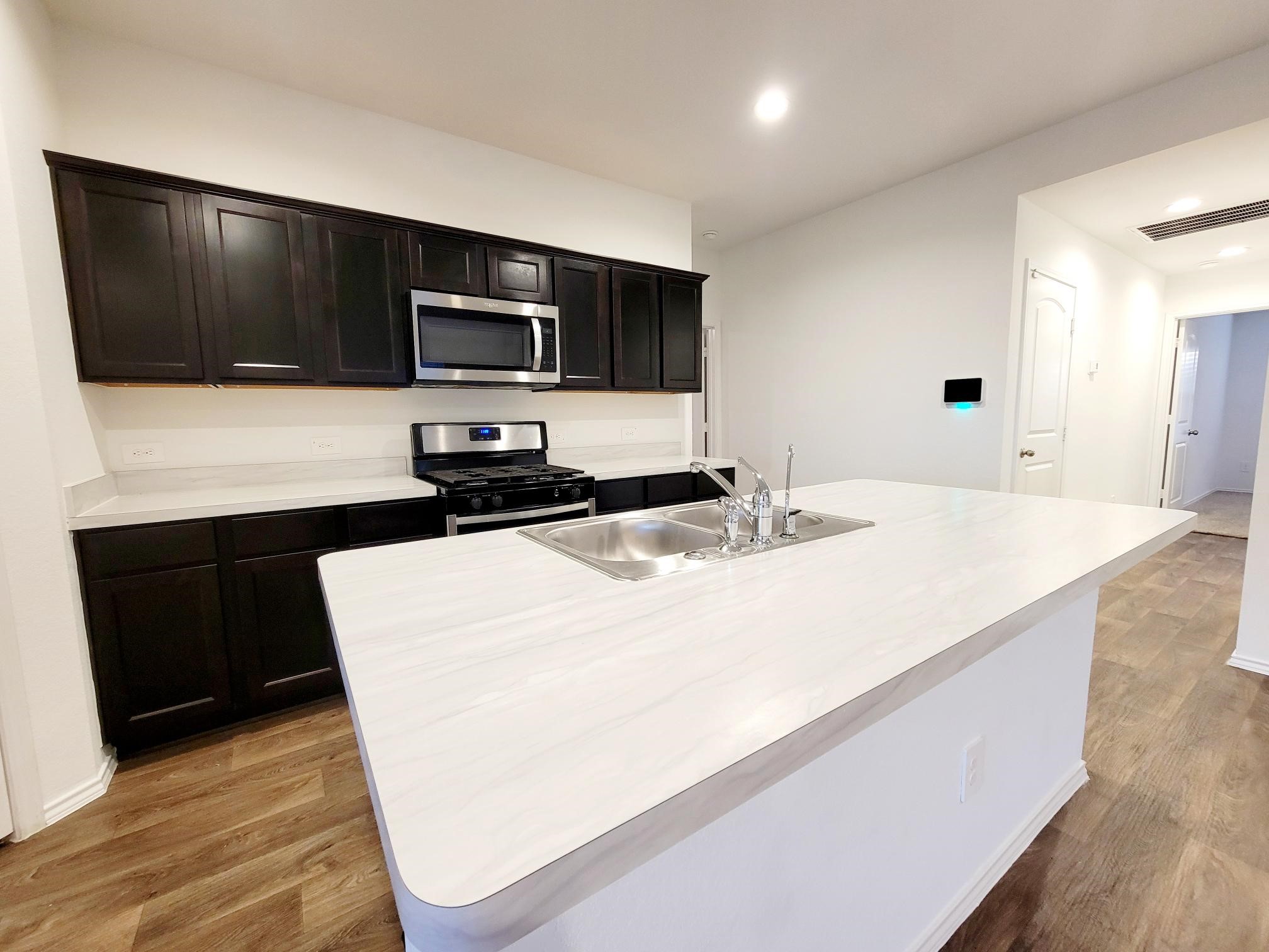 21522 Violet Ridge Road Katy, TX 77449 - Photo 21 of 40 a kitchen with a sink and a microwave