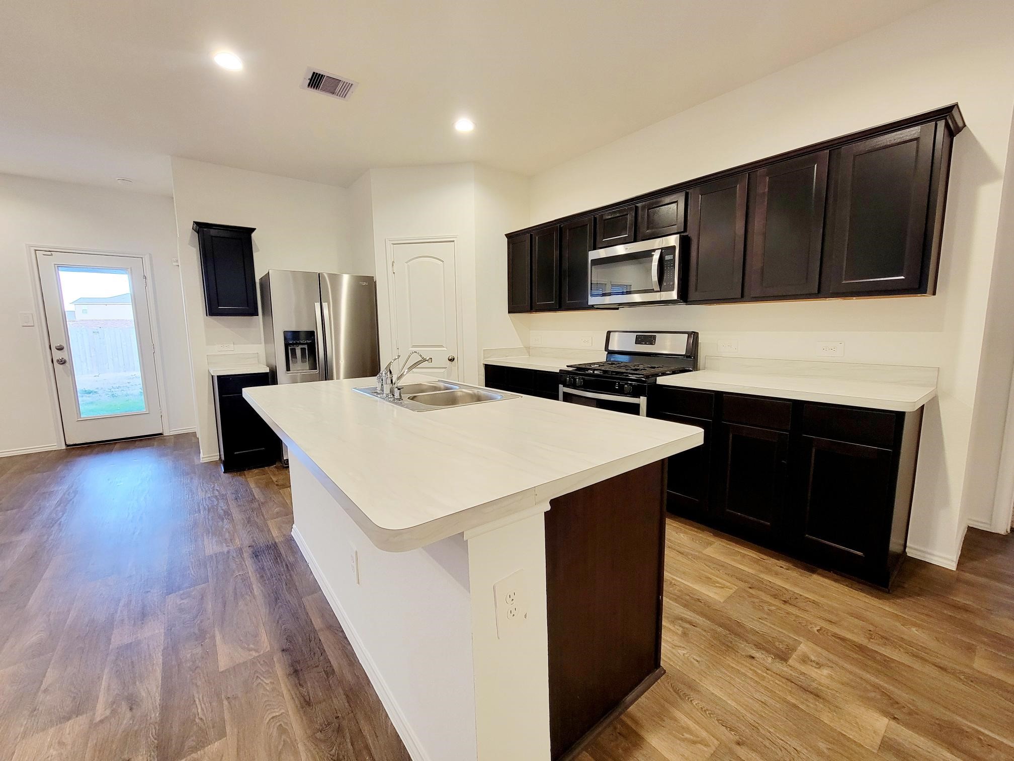 21522 Violet Ridge Road Katy, TX 77449 - Photo 22 of 40 a kitchen that has a sink and a microwave in it