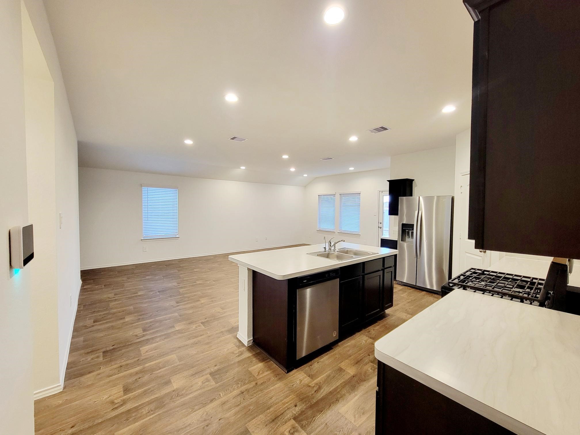 21522 Violet Ridge Road Katy, TX 77449 - Photo 23 of 40 a kitchen with a stove and a refrigerator