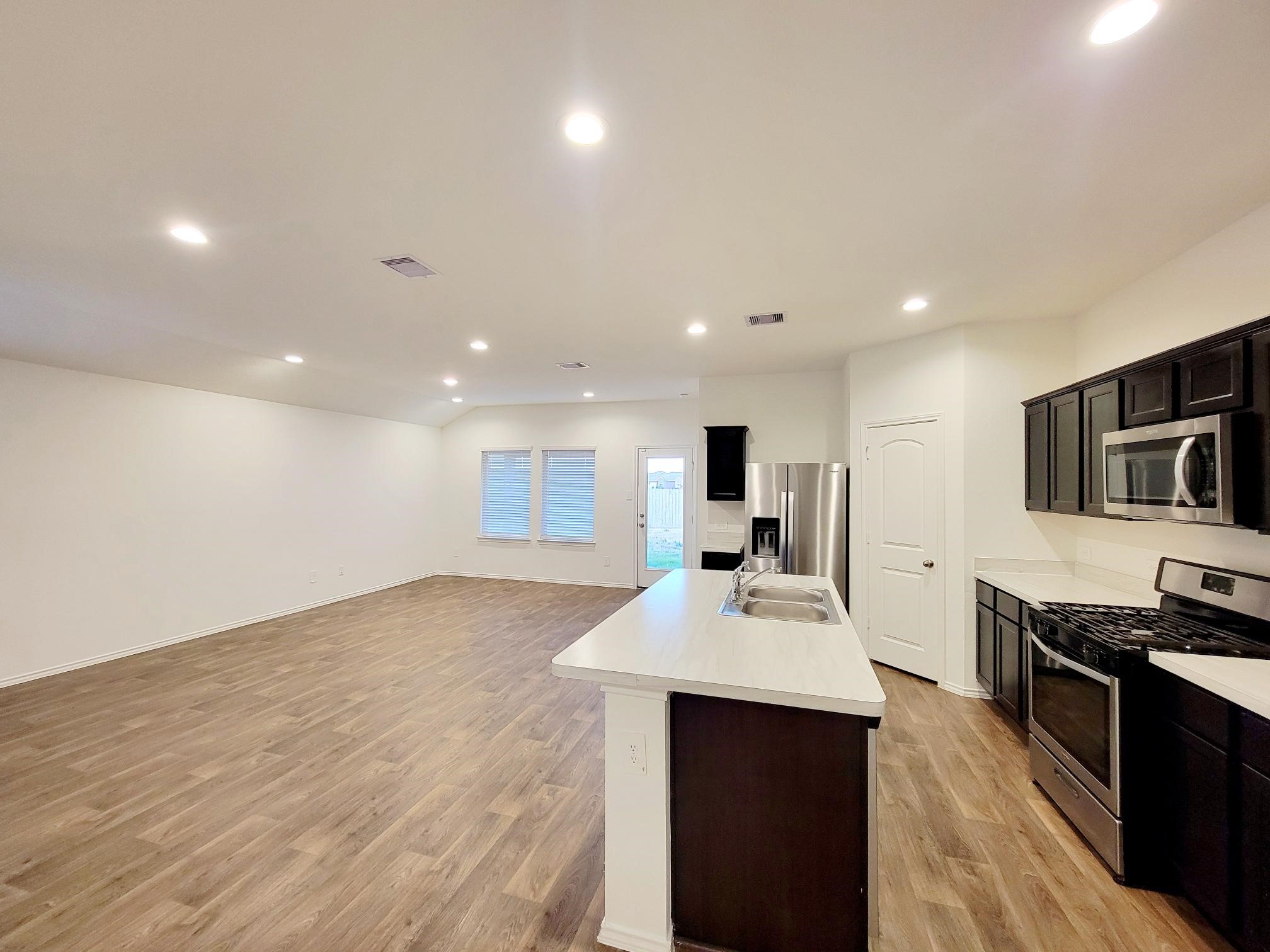 21522 Violet Ridge Road Katy, TX 77449 - Photo 24 of 40 a kitchen with stainless steel appliances a sink stove and refrigerator
