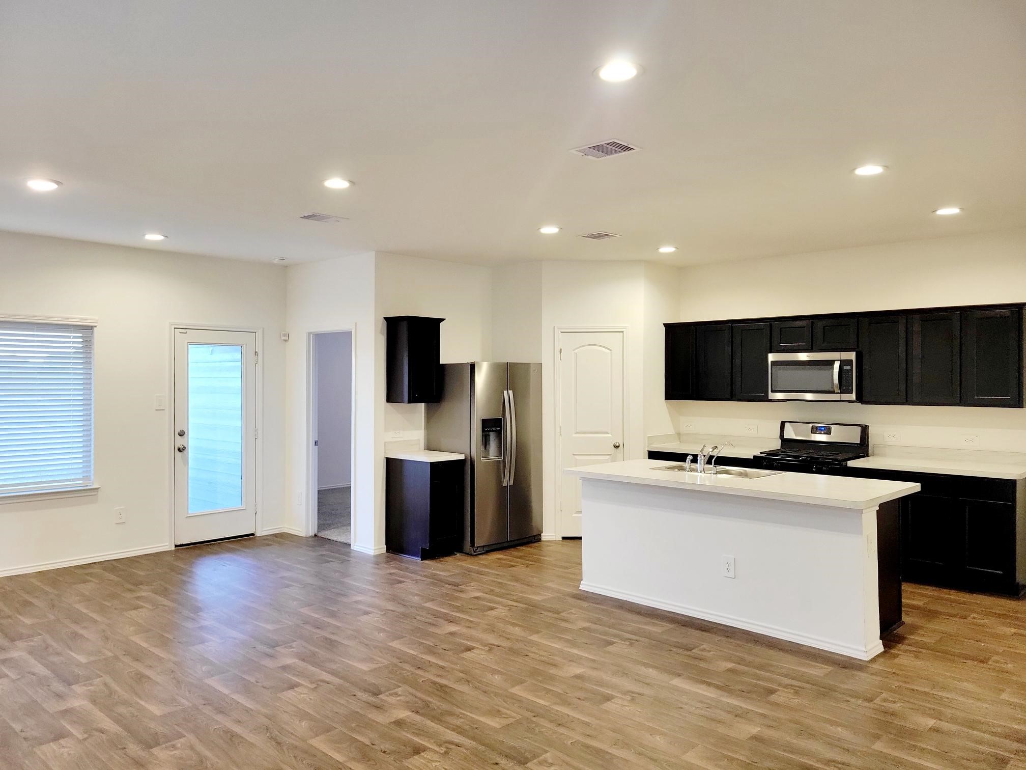 21522 Violet Ridge Road Katy, TX 77449 - Photo 9 of 40 a kitchen with stainless steel appliances a refrigerator and a stove top oven