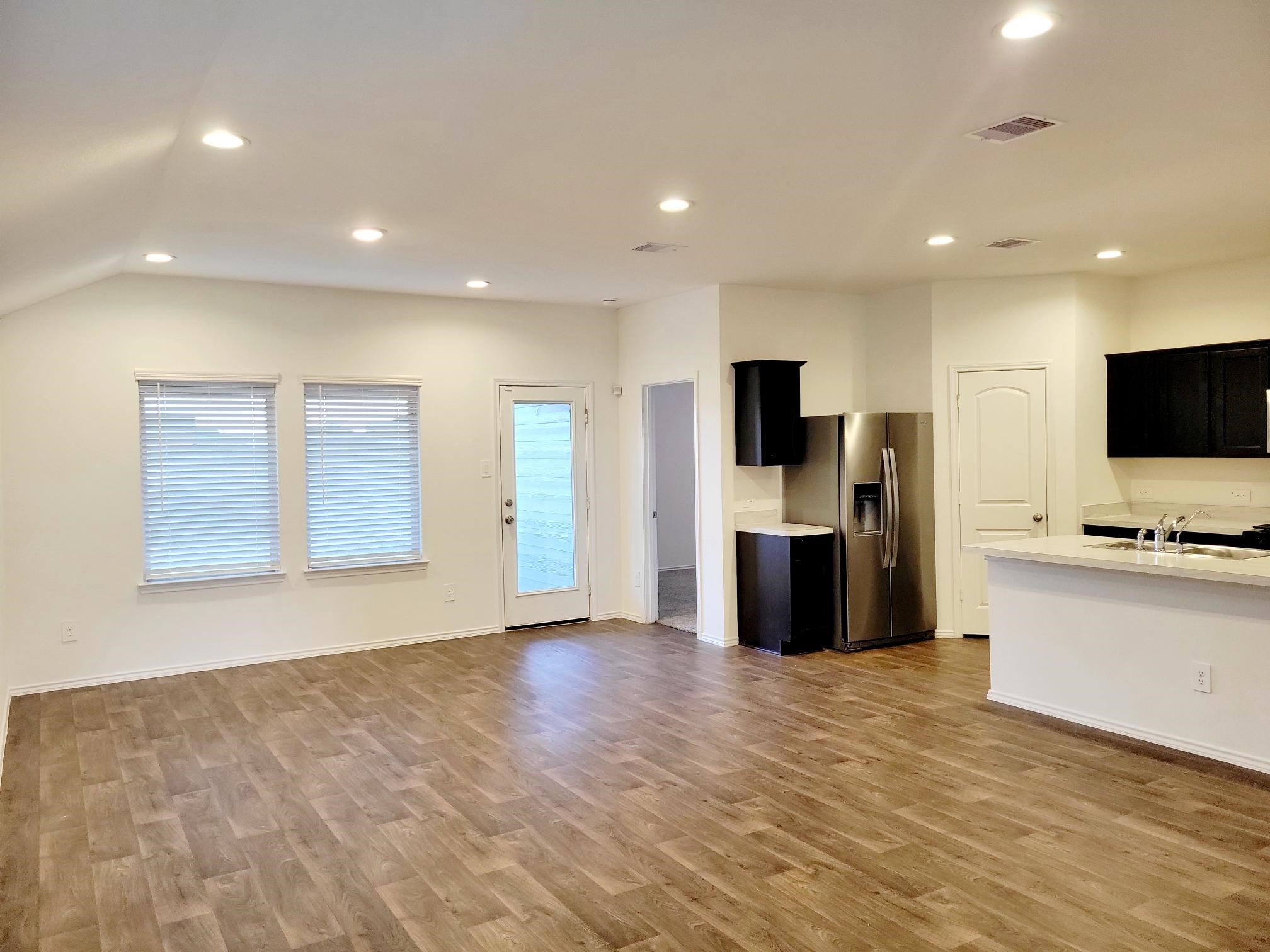21522 Violet Ridge Road Katy, TX 77449 - Photo 10 of 40 a view of a kitchen with a sink and a refrigerator