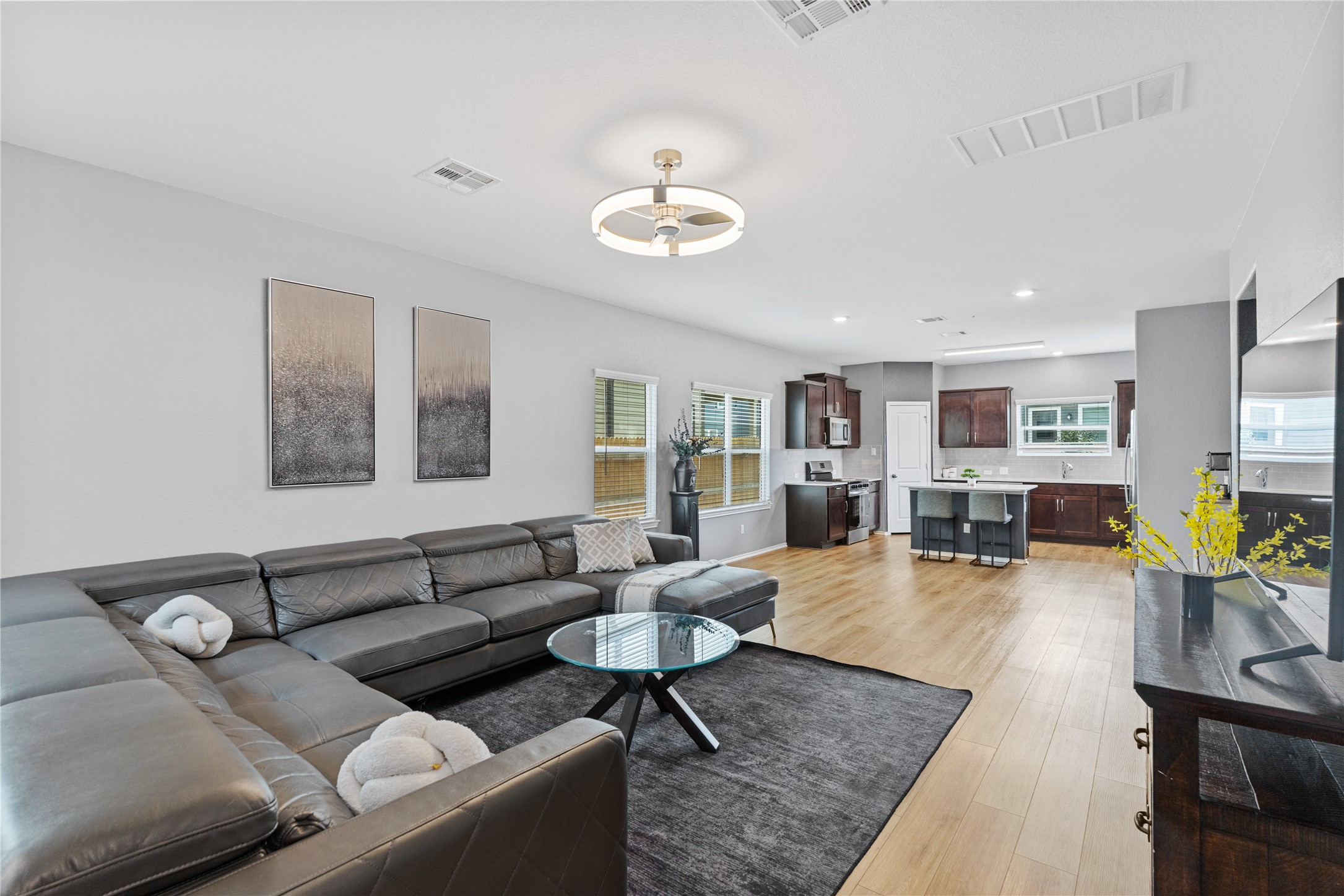 425 Perfect World Loop Jarrell, TX 76537 - Photo 4 of 29 Expansive living area featuring wood-finish flooring, recessed lighting, and a contemporary ceiling fan