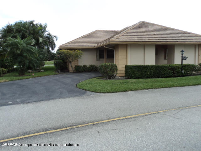 314 Cedar Key Circle Atlantis, FL 33462 - Photo 2 of 23 a front view of a house with a yard