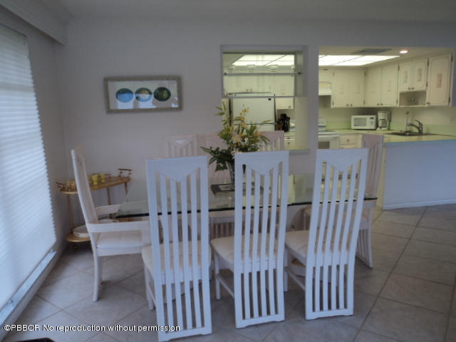 314 Cedar Key Circle Atlantis, FL 33462 - Photo 12 of 23 a view of a dining room with furniture and window